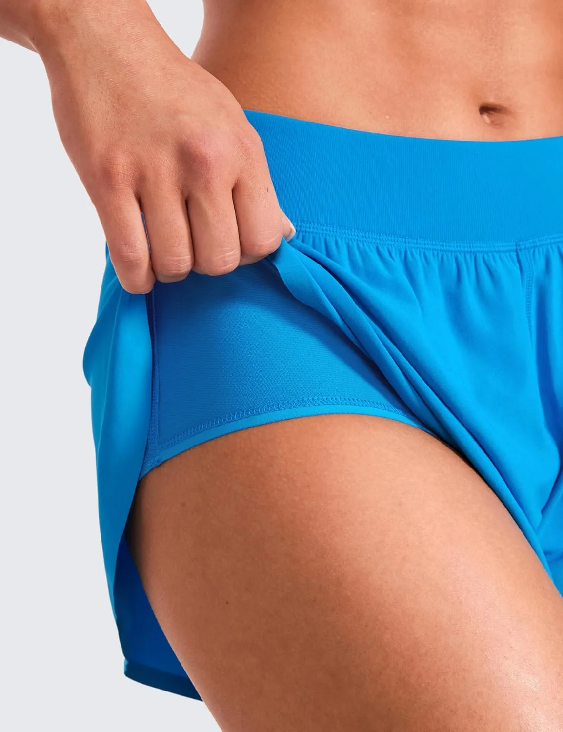 CRZ YOGA Mid Waisted Dolphin Athletic Shorts for Women 4" Lightweight High Split for Gym Workout with Liner Quick Dry